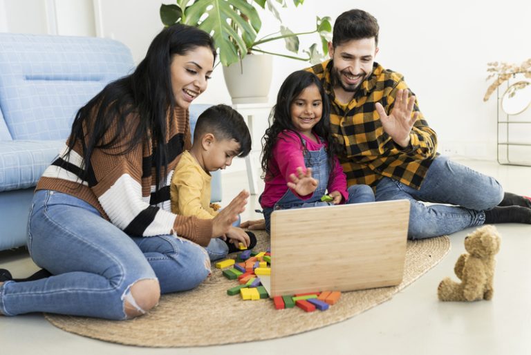 happy-family-in-living-room-with-laptop-video-call